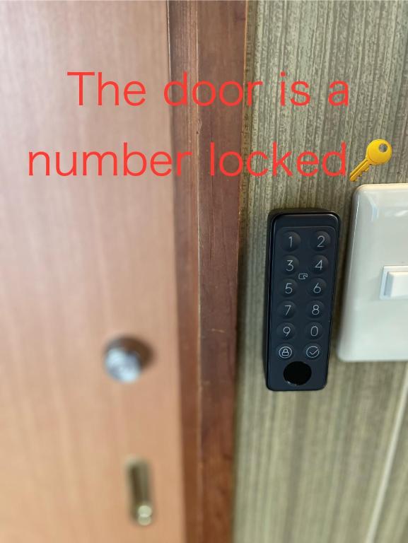 a door with a number locked with a remote control at Guest House BONITO in Kochi