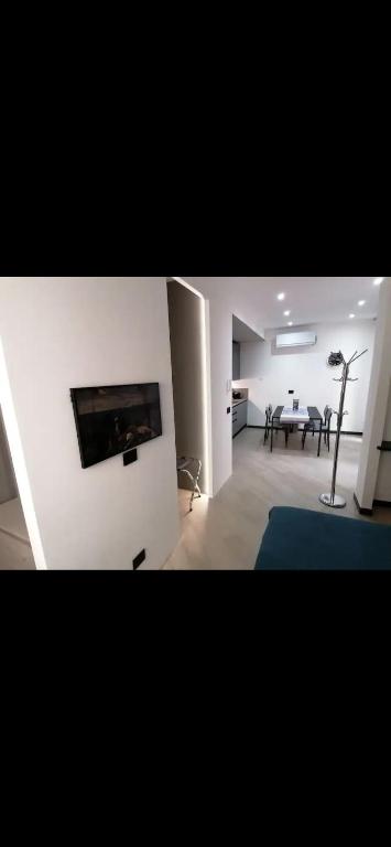 a living room with a table and a television on a wall at Casa Edera in Monterosso al Mare