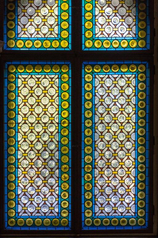 a stained glass window with plates on it at The Benjamin House in Rīga