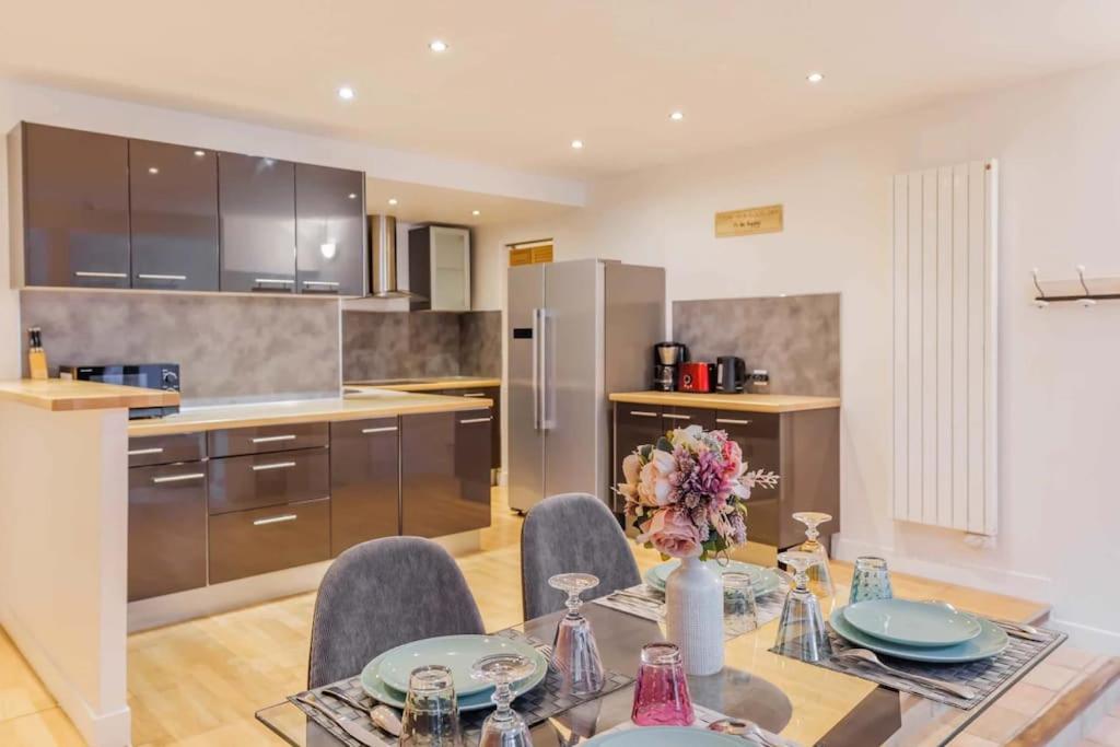 une cuisine et une salle à manger avec une table et des chaises dans l'établissement Sublime Appartement Parisiens, à Paris