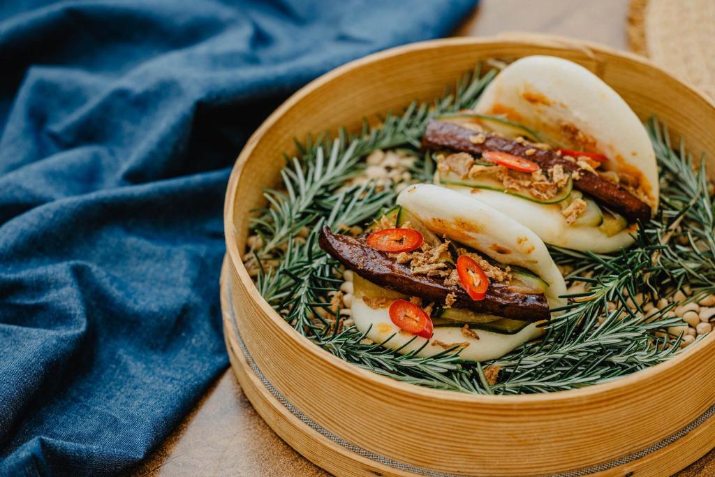 a wooden bowl filled with food on a table at Vale d'El Rei Hotel & Villas in Carvoeiro