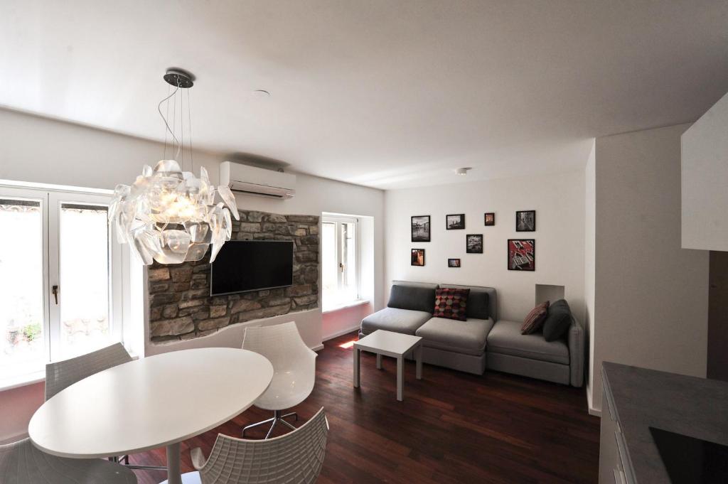 a living room with a couch and a table at Historic center shelter in Piran