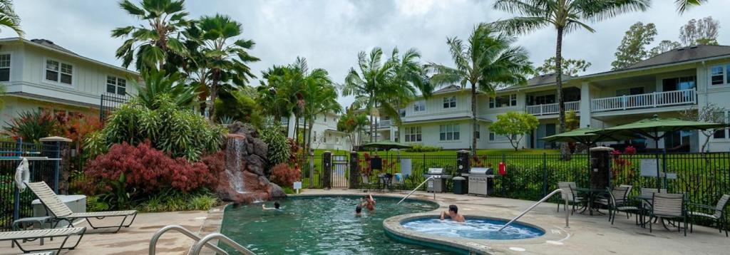 a pool at a resort with people in it at Plantation at Princeville 1322 in Princeville