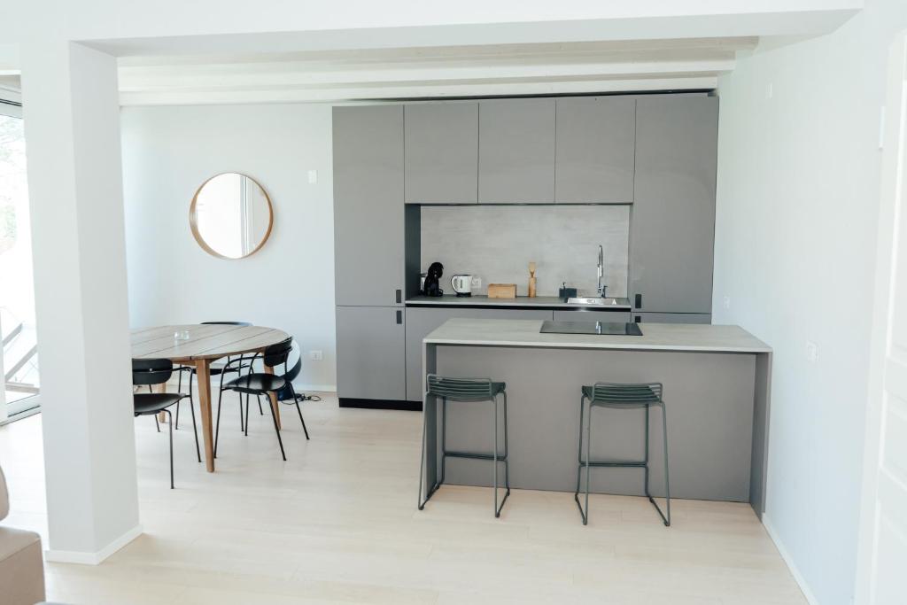 a kitchen with a counter and a table at C House Rooms Lake in Peschiera del Garda