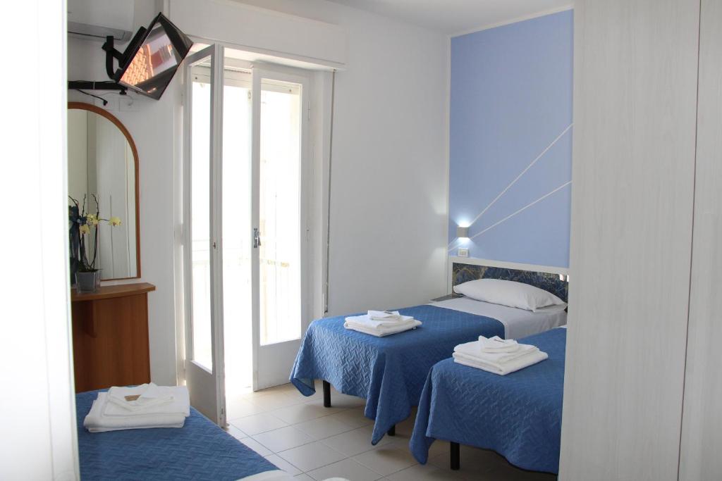 Postel nebo postele na pokoji v ubytování Martina's Hotel