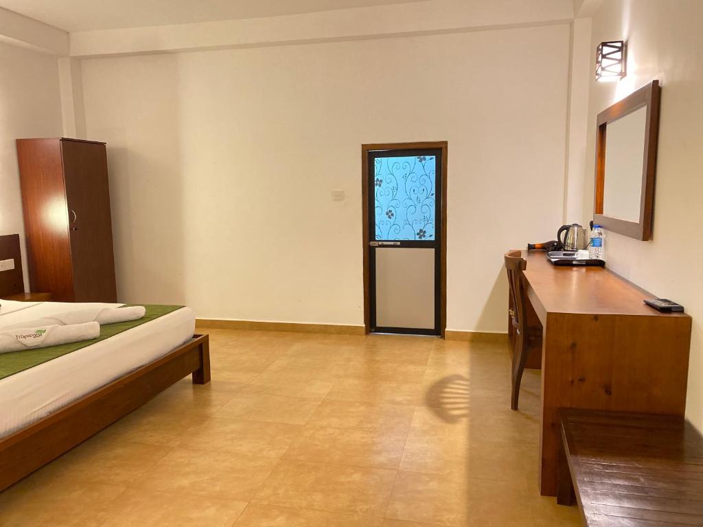 Postel nebo postele na pokoji v ubytování Tropicara Resort
