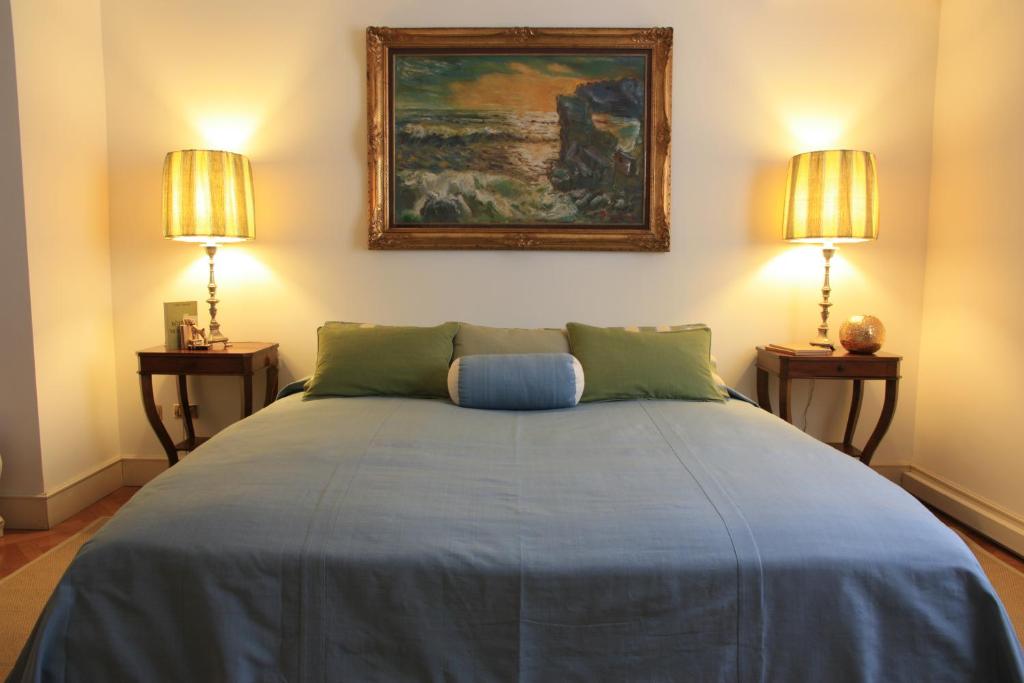 a bedroom with a large bed with two lamps at Casa Fracasso in Verona