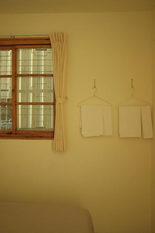 a living room with a window and two white towels at Maru in Tainan
