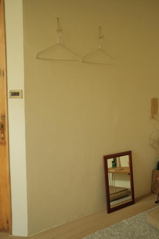 a mirror on a wall next to a room at Maru in Tainan