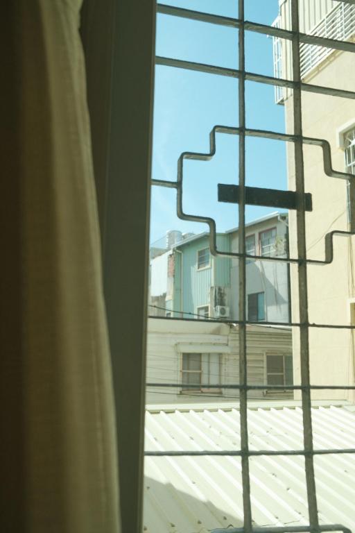 a window with a view of a building at Maru in Tainan