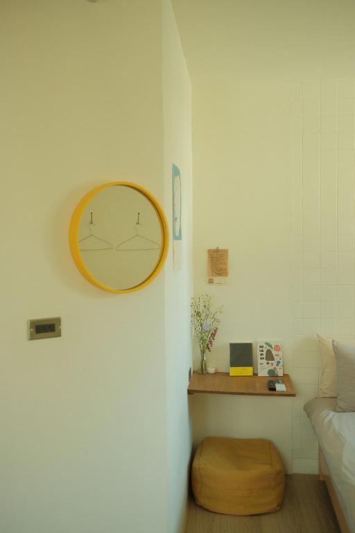 a clock hanging on a wall in a room at Maru in Tainan