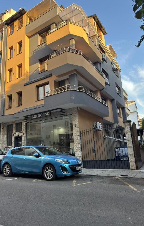 a blue car parked in front of a building at M&D in Nesebar