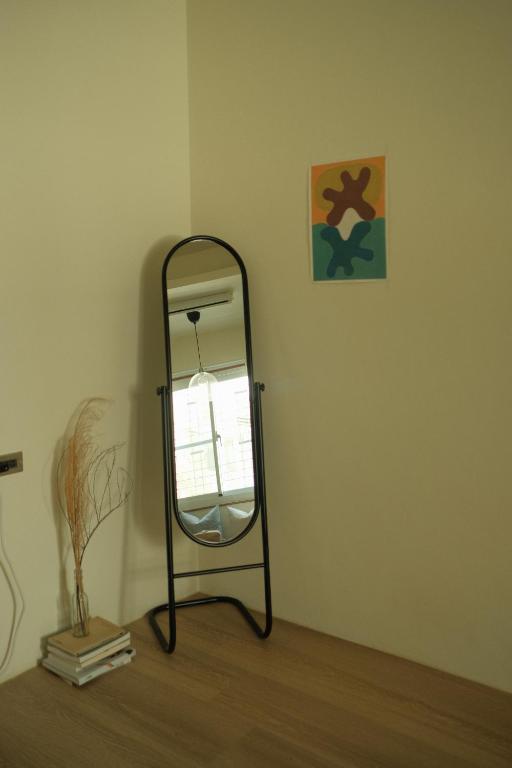 a mirror sitting on the floor in a room at Maru in Tainan