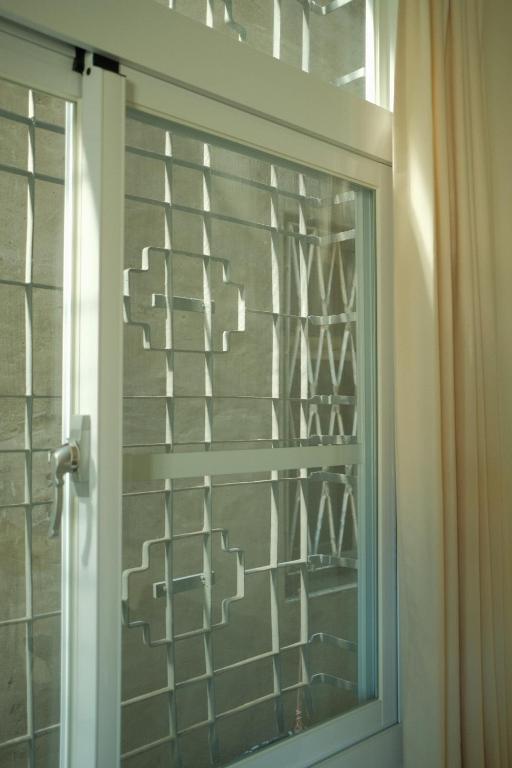 a glass door with a window in a bathroom at Maru in Tainan