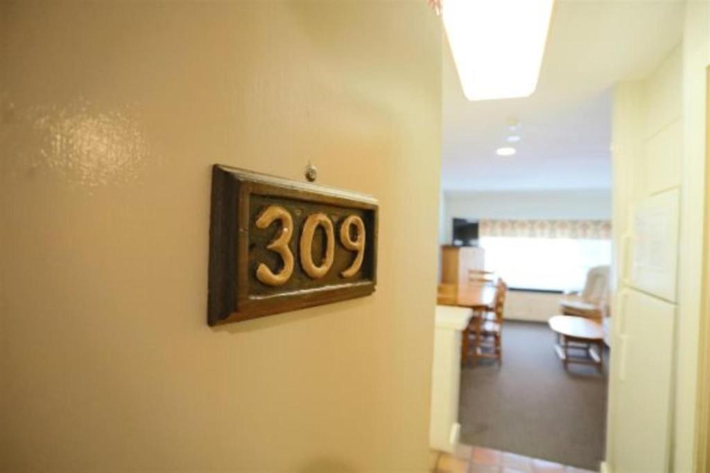 a clock hanging on a wall in a living room at Inns of Waterville Valley 309 in Waterville Valley