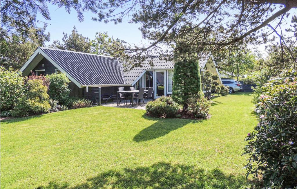 a small house with a yard with a grass field at Gorgeous Home In Hemmet With Wifi in Hemmet