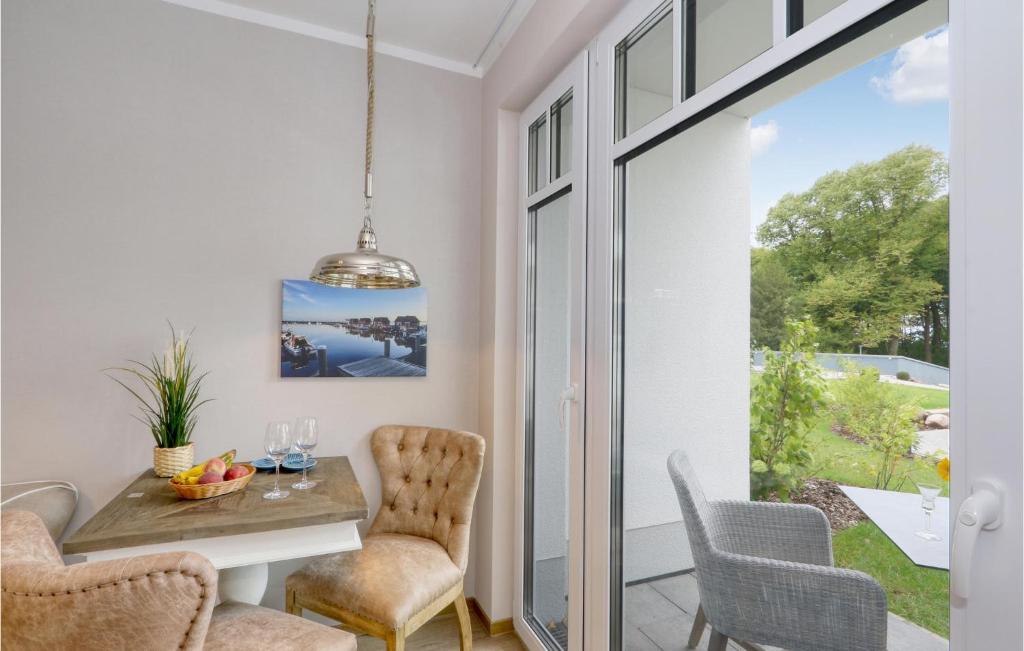 a dining room with a table and chairs at Baltischer Hof Apartment 20 in Boltenhagen