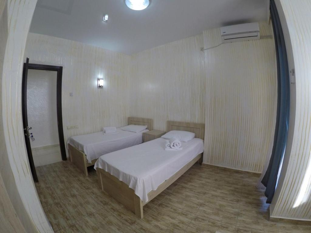 Postel nebo postele na pokoji v ubytování New Batumi Inn Hotel