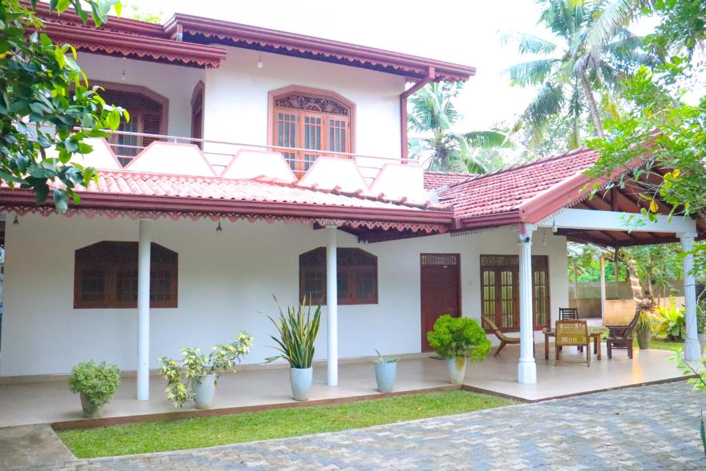 a white house with a red roof at Dream Villa - Weligama in Weligama