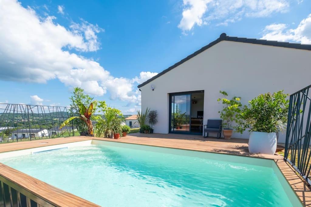 a swimming pool on the balcony of a house at Sunset villa in Trélissac