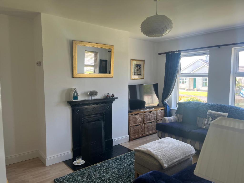 una sala de estar con un sofá y una silla en Portrush Holiday Haven, en Portrush