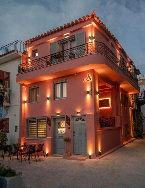 a pink house with a balcony on top of it at ALIVIO Lux Residences in Nafplio