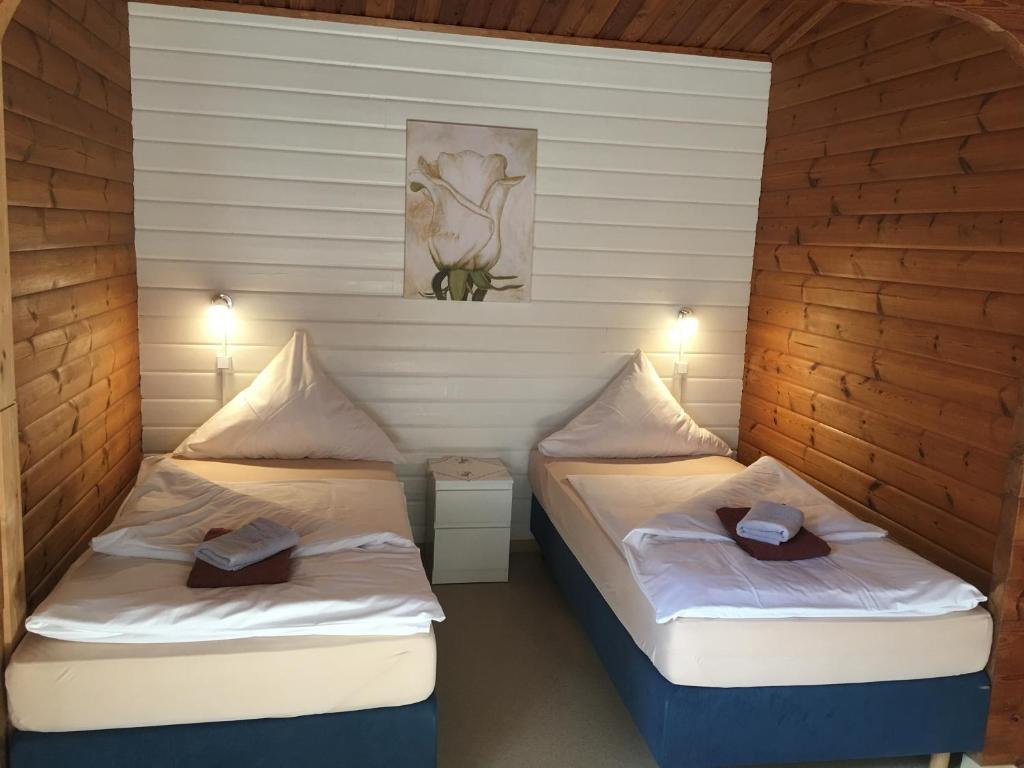 two beds in a room with hats on them at ABB Sportcenter Gänsefurth, Doppelzimmer ohne Küche, Standard Doppelzimmer mit Küche in Hecklingen