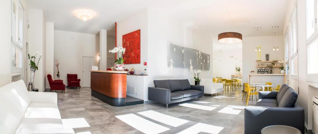 a lobby with chairs and a bar in a building at Hotel Al Prato in Padova