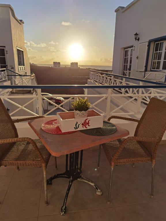 a table with a box on top of a balcony at Atardecer in La Santa