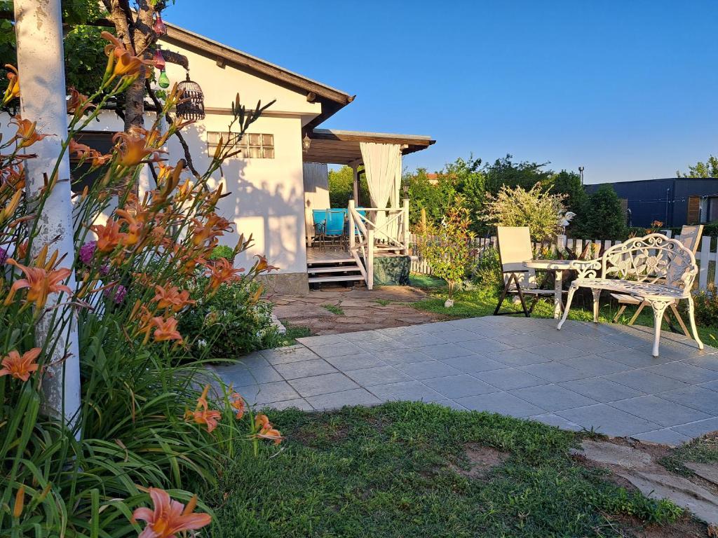 a patio with a table and chairs in a yard at Villa Anastasia in Sinemorets