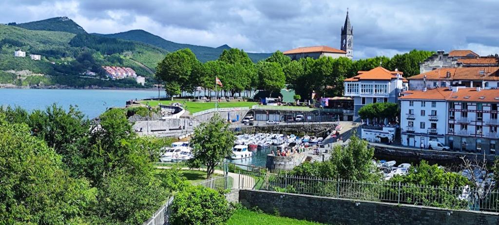 a view of a town with a river and buildings at RINCÓN DEL MAR Mundaka in Mundaka