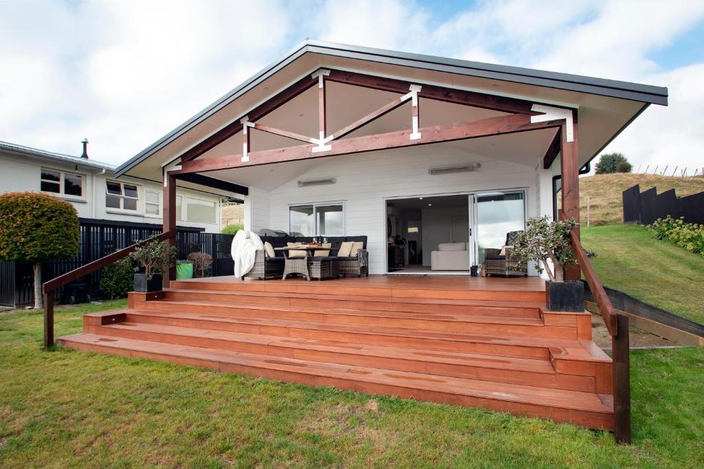 a wooden deck with a pergola at Clareview Cottage in Rotorua