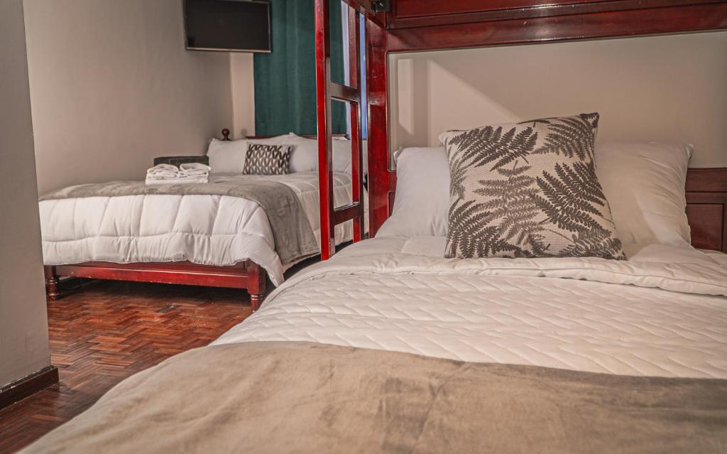 Postel nebo postele na pokoji v ubytování UKUKU Hostel
