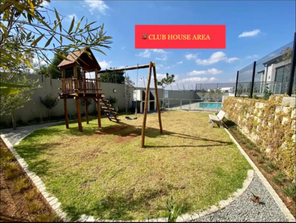 a playground with a swing set in a yard at Dubai 8 in Midrand
