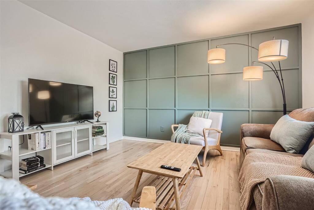 a living room with a couch and a tv at Serene, Spacious Home in Quiet Neighborhood with Fenced Yard in Aurora