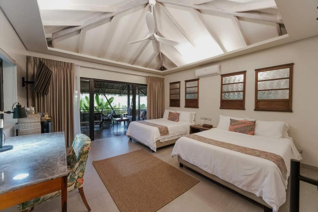 Postel nebo postele na pokoji v ubytování Kaimana Resort Siargao