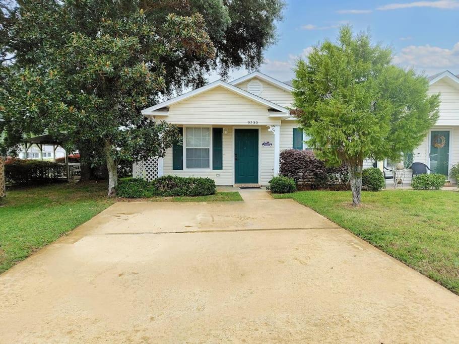 a house with a green door and a driveway at 2 BR Beach Getaway, Perdido Key, NAS, Pensacola in Pensacola