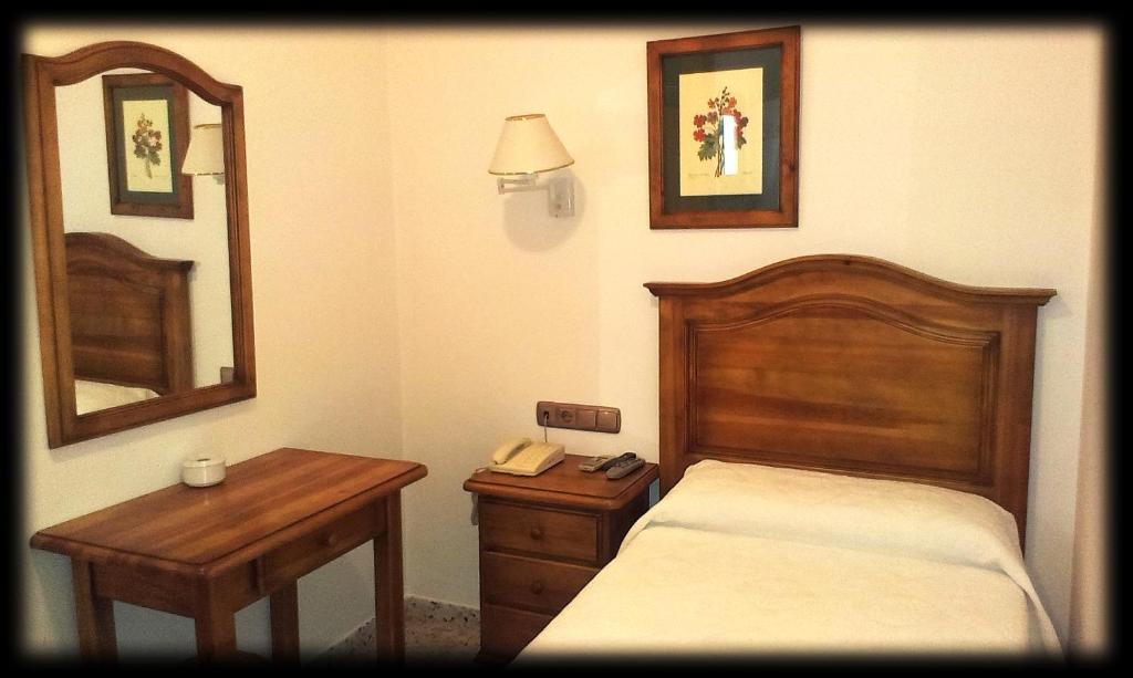 Postel nebo postele na pokoji v ubytování Hotel Bonilla