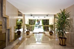 a large hallway with potted plants in a building at L'Azur Promenade in Nice