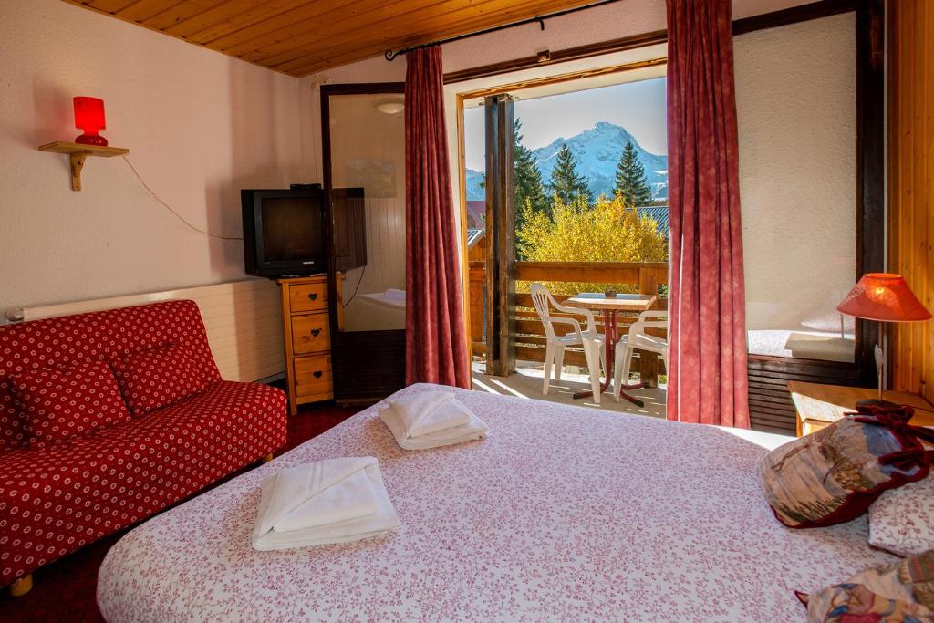 Postel nebo postele na pokoji v ubytování Hotel Le Cairn