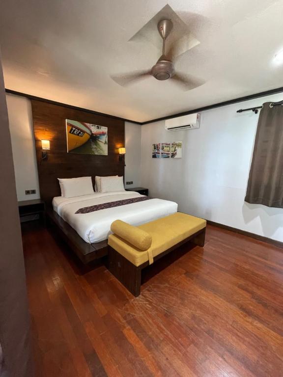 a bedroom with a bed and a ceiling fan at Perhentian Island Resort in Perhentian Islands