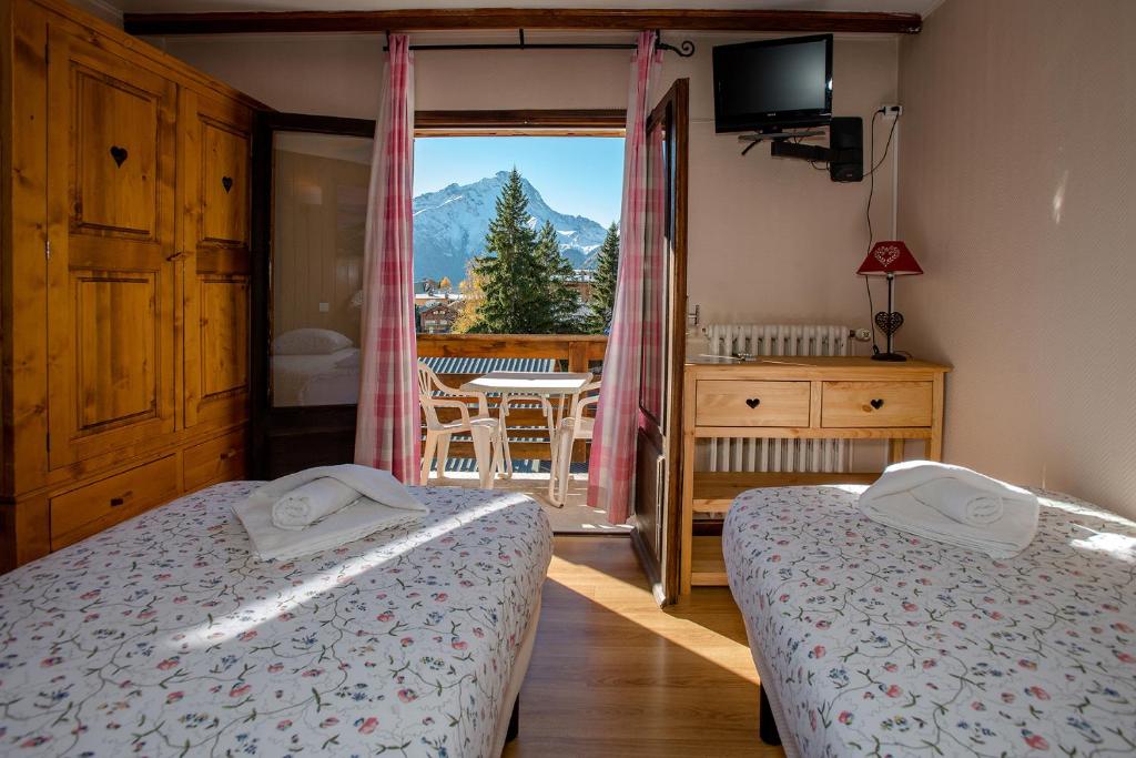 Postel nebo postele na pokoji v ubytování Hotel Le Cairn