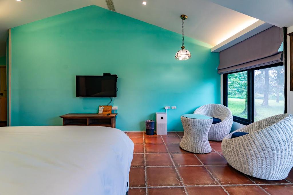una camera con un letto, due sedie e una TV di whitesun a Ji'an