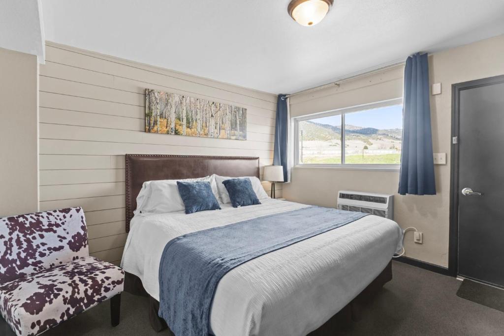 a bedroom with a bed and a chair and a window at Lost Trail in Lava Hot Springs