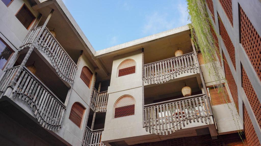 a building with white balconies on the side of it at Amnaya Resort Nusa Dua in Nusa Dua