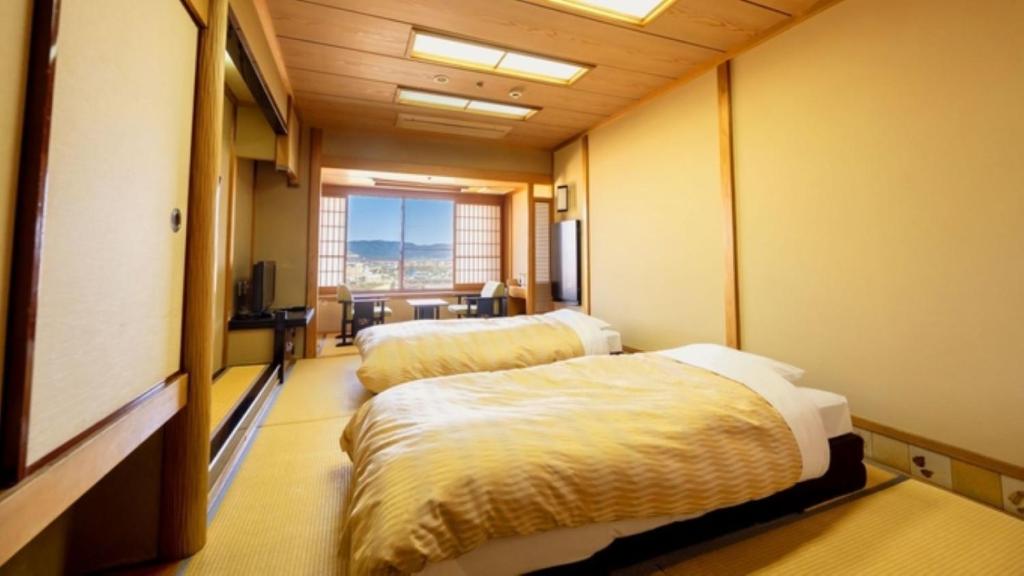 Postel nebo postele na pokoji v ubytování Nara Park Hotel