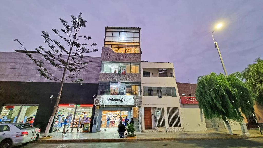 a tall building on the corner of a street at Hostal LUK'ANAS in Trujillo
