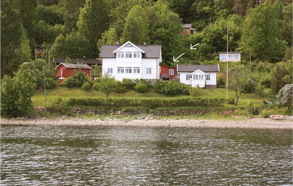 a house on the shore of a body of water at 1 Bedroom Cozy Home In Sætre in Sætre