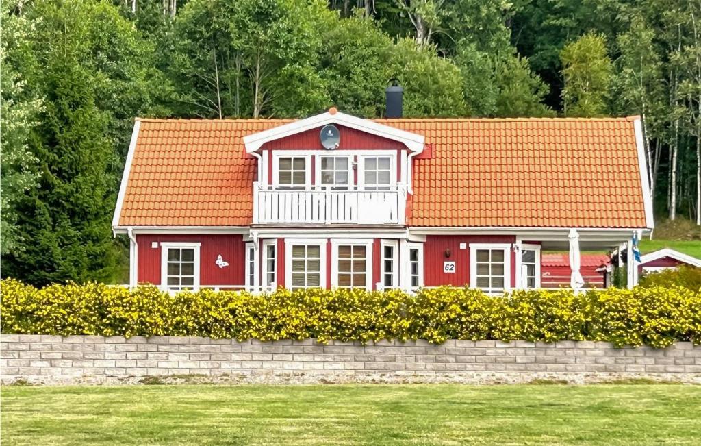 a red and white house with an orange roof at Amazing Home In Strömstad With Sauna in Lökholmen