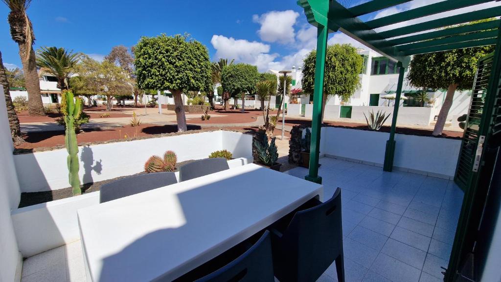 a white table and chairs on a patio at La Islita in Playa Blanca